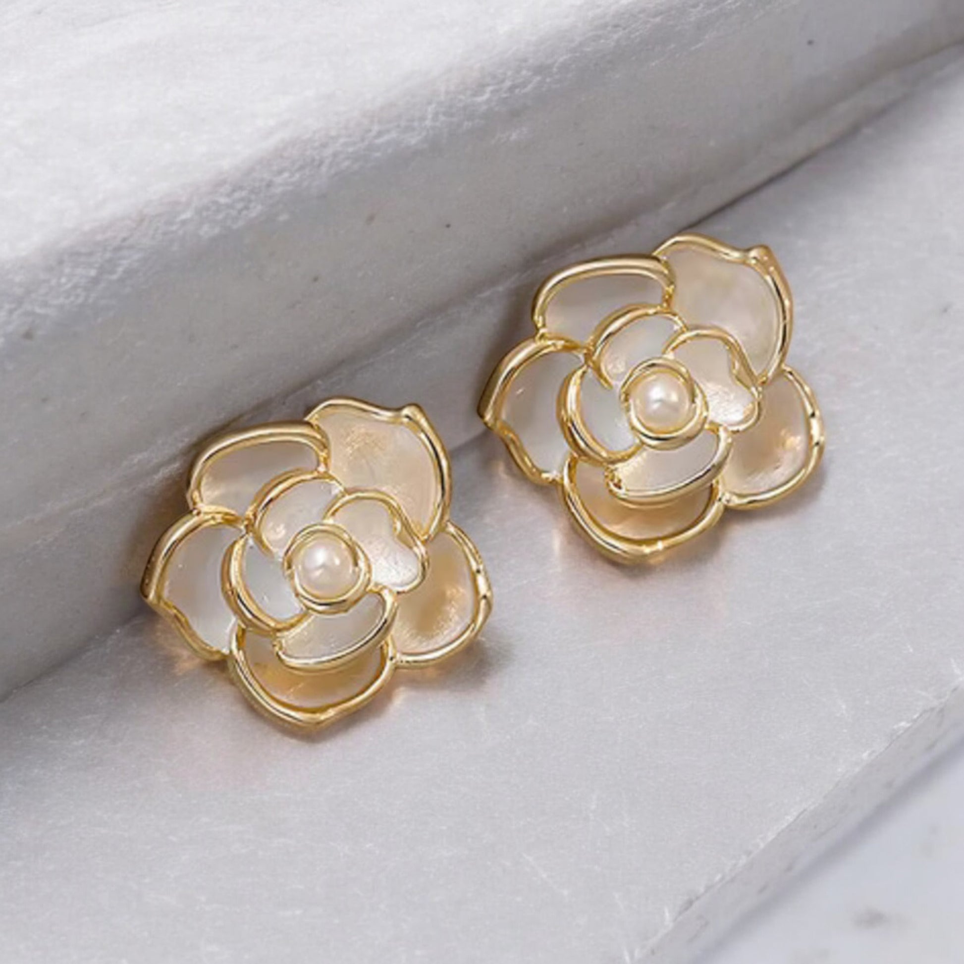 Parisian_Camellia_Enamel_Studs _Lifeluxe jewelry trending beautiful
Step into the world of French romance with these stunning Parisian Camellia Enamel Studs. Perfect for the modern woman who appreciates both elegance and sophistication, these earrings are a luxurious addition to any jewelry collection. Inspired by the delicate beauty of camellia flowers, they are designed to bring a touch of refined charm to your look.

Features:

Sophisticated Design: Features a beautifully crafted white enamel camellia 